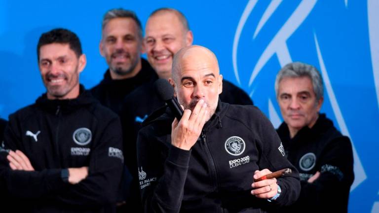 Manchester City’s Spanish manager Pep Guardiola (C) attends an event for fans with members of the Manchester City football team following an open-top bus parade through Manchester, north-west England on May 23, 2022, to celebrate winning the 2021-22 Premier League title. AFPPIX