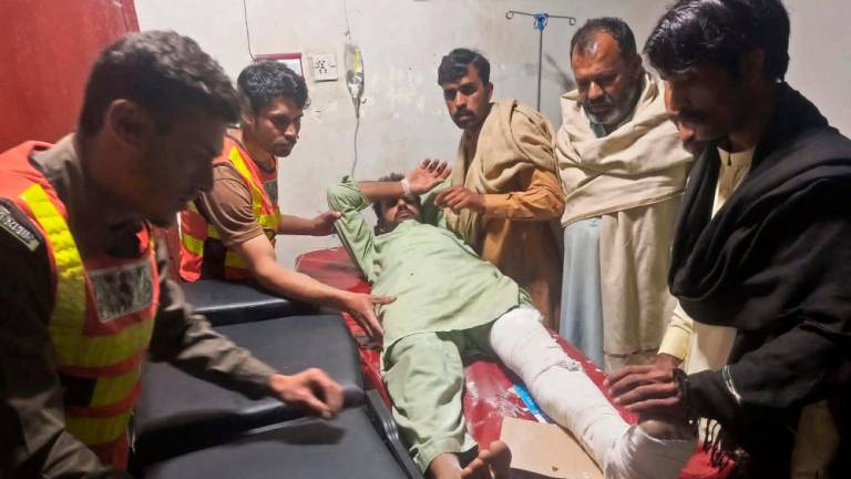 This handout photograph released by the Pakistan’s Emergency Rescue 1122 Service on March 22, 2023 shows rescue workers attending an earthquake victim at a hospital in Swat of Khyber Pakhtunkhwa province. AFPPIX