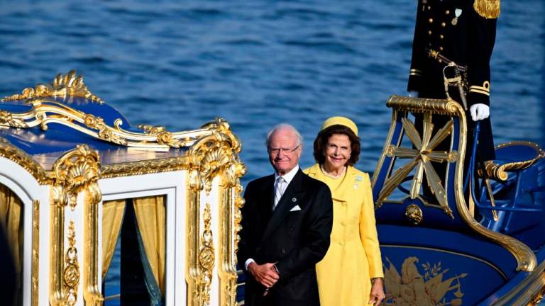 King Carl XVI Gustaf of Sweden (L) and Queen Silvia of Sweden stand on a royal boat during festivities to celebrate the 50th anniversary of Sweden’s King Carl XVI Gustaf’s accession to the throne at the Royal Palace in Stockholm, Sweden, on September 16, 2023. AFPPIX