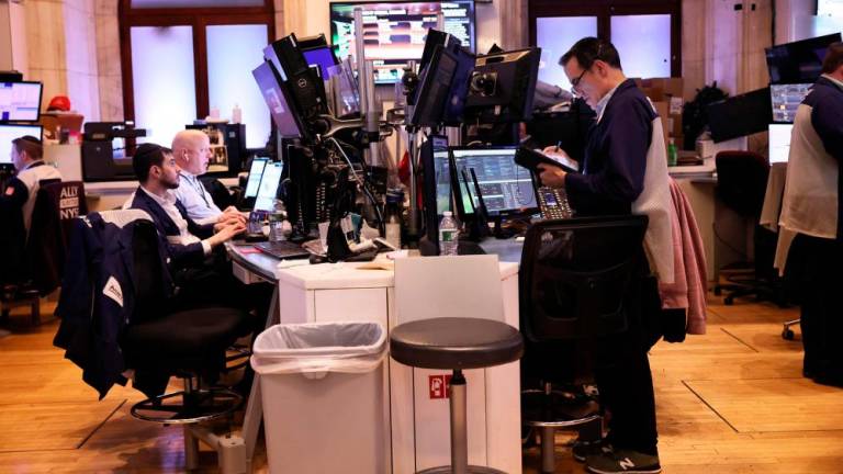 Traders working on the floor of the New York Stock Exchange during the afternoon session on Mondaym Jan 9. – AFPpic