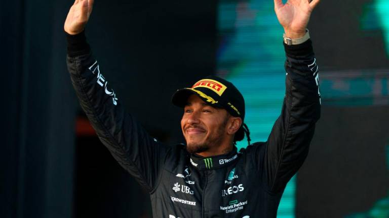 Second-placed Mercedes’ British driver Lewis Hamilton celebrates on the podium after the 2023 Formula One Australian Grand Prix at the Albert Park Circuit in Melbourne on April 2, 2023. AFPPIX