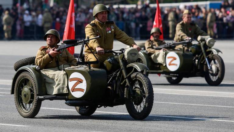 File pix: Participants wearing historical uniforms ride in WWII-era motorcycles adorned with stickers of the letter Z, which has become a symbol of support for Russian military action in Ukraine, during a military parade, which marks the 77th anniversary of the Soviet victory over Nazi Germany in World War Two, in Novosibirsk on May 9, 2022. AFPPIX