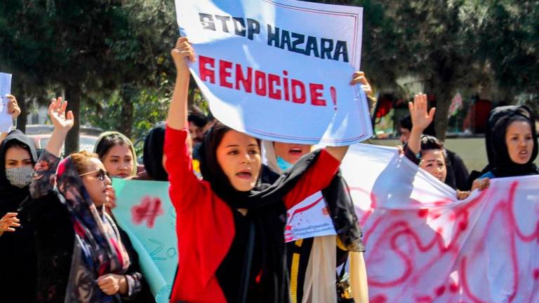 Afghan women display placards and chant slogans during a protest they call ‘Stop Hazara genocide’ a day after a suicide bomb attack at Dasht-e-Barchi learning centre, in Kabul on October 1, 2022. AFPPIX