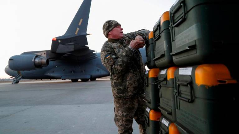 File photo: A Ukrainian service member unloads Lithuania's military aid including Stinger anti-aircraft missiles, delivered as part of the security support package for Ukraine by a 17 Globemaster III plane, at the Boryspil International Airport outside Kyiv, Ukraine, February 13, 2022. REUTERSpix