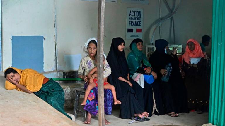 In this picture taken on August 11, 2022, Rohingya refugees wait to receive treatment in a maternity ward of a medical centre in Kutupalong refugee camp in Ukhia. AFPPIX
