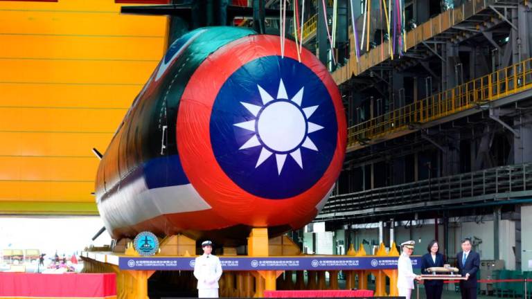 Taiwan President Tsai Ing-wen (2nd R) receives a submarine model in front of Taiwan’s first locally built submarine during the vessel’s unveiling ceremony at the CSBC Corporation shipbuilding company in Kaohsiung on September 28, 2023/AFPPix