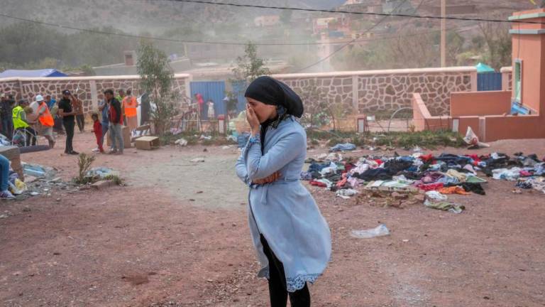 A woman waits to receive assistance in their village between Marrakech and Taroudant in the Atlas mountain range on September 17, 2023, in the aftermath of a powerful earthquake. AFPPIX