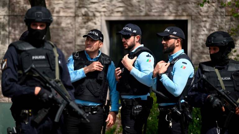 Portuguese police officers stand guard in front of the Ismaili Islamic centre in Lisbon, after two people died following a knife attack that wounded several others, on March 28, 2023. AFPPIX