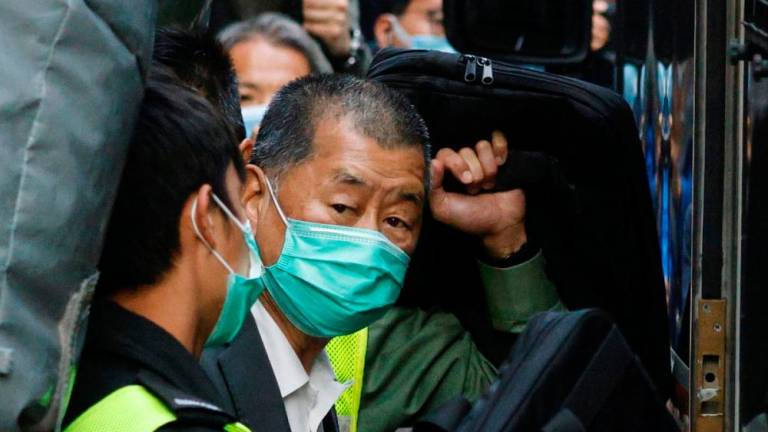 Media tycoon Jimmy Lai, founder of Apple Daily, looks on as he leaves the Court of Final Appeal by prison van, in Hong Kong, China February 1, 2021. REUTERSPIX