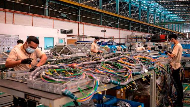 Employees of an electronics factory adhere to the Standard Operating Procedures (SOP) set by the government to curb the spread of COVID-19 while working at the factory around Kota Damansara. BERNAMApix