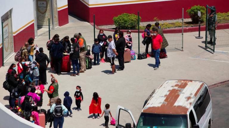File photo: Asylum-seeking migrants from Mexico and Central America walk near the San Ysidro Port of Entry border crossing with the U.S., in Tijuana, Mexico May 5, 2022. REUTERSpix