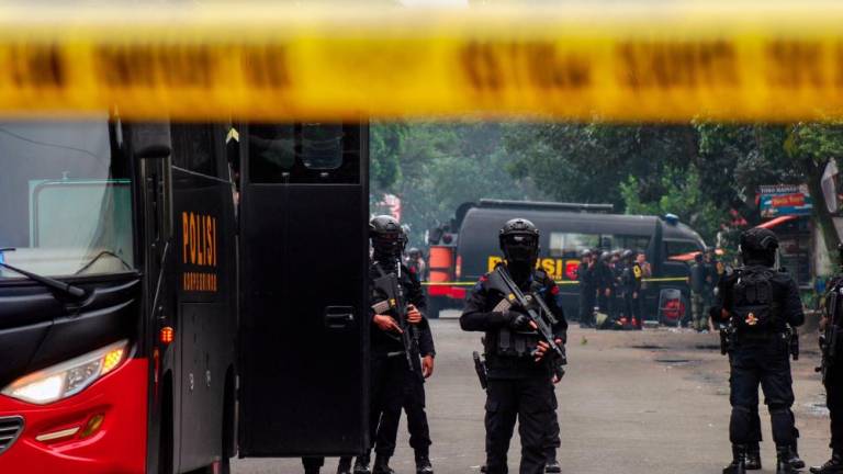 Police secure the site of a suicide bombing outside a police station at Astanaanyar in Bandung, West Java province, on December 7, 2022. - AFPPIX