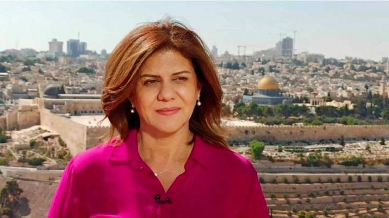 (FILES)This undated handout file photo released by the Doha-based Al-Jazeera TV, shows the channel's veteran journalist Shireen Abu Aqleh (Akleh) during one of her reports from Jerusalem. - AFPPIX