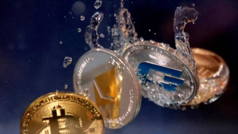 Representations of cryptocurrencies bitcoin, ethereum and dash are shown plunging into water in this illustration. – Reuterspix