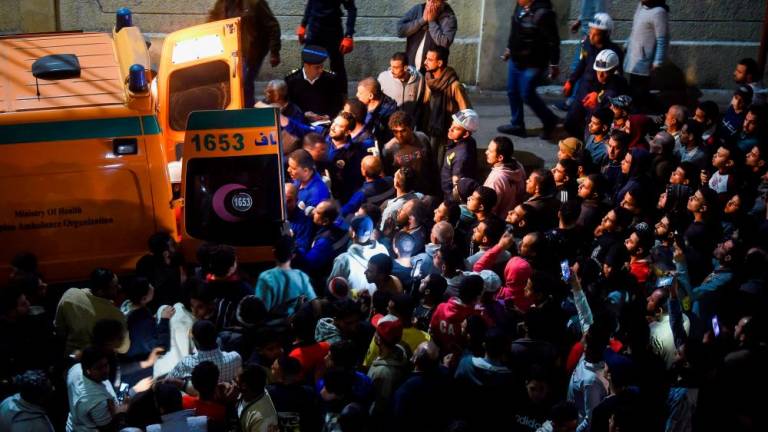 People gather around an ambulance next to the scene of a train crash in the city of Qalyub in Al Qalyubia Governorate, north of Cairo, Egypt, March 7, 2023/REUTERSPix