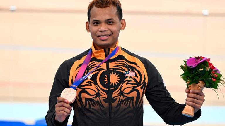 Bronze medallist Malaysia's Muhammad Shah Firdaus Sahrom poses during the medal ceremony for the men's sprint final of cycling track event during the Hangzhou 2022 Asian Games in Hangzhou//AFPix