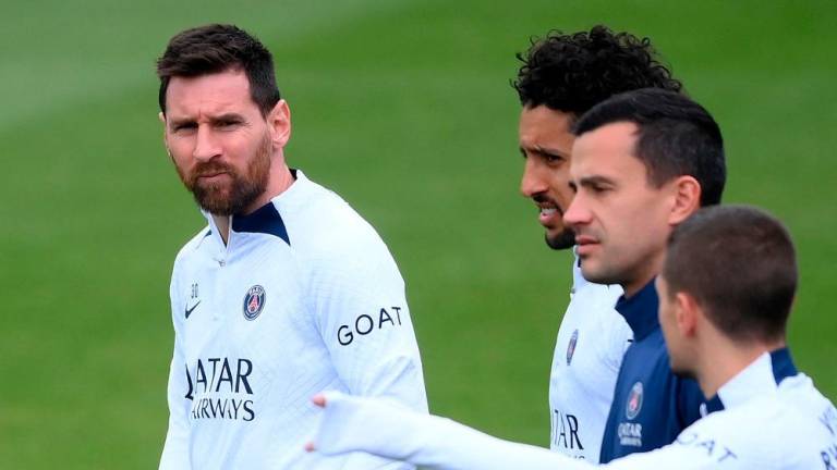 Lionel Messi (L) looks on during a training session in Saint-Germain-en-Laye, in the north-western outskirts of Paris, on May 12, 2023, on the eve of the L1 football match against Ajaccio. AFPPIX