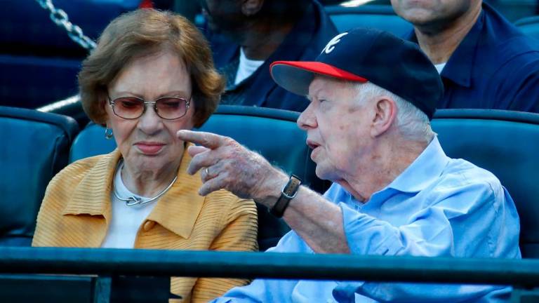 Filepix: Former President Jimmy Carter and his wife Rosalynn look on prior to the game between the Atlanta Braves and the Toronto Blue Jays at Turner Field on September 17, 2015 in Atlanta, Georgia/AFPPix