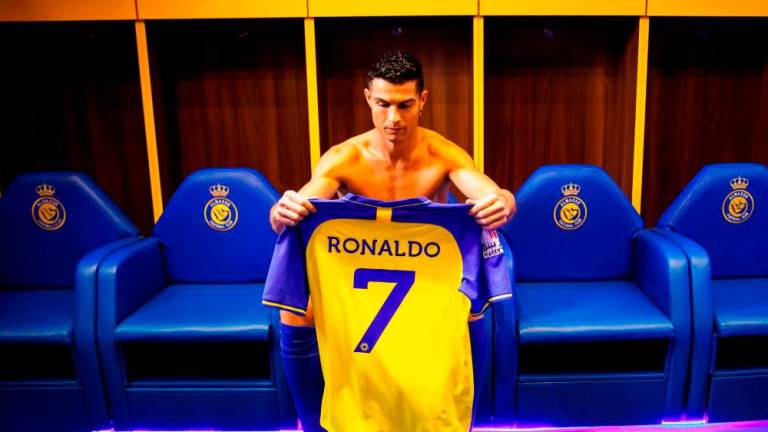 Filepix: A handout picture released by Saudi Arabia’s al-Nassr football club shows Al-Nassr’s new Portuguese forward Cristiano Ronaldo holding the club’s number seven jersey ahead of his unveiling ceremony at the Mrsool Park Stadium in the Saudi capital Riyadh on January 3, 2023/AFPPIX