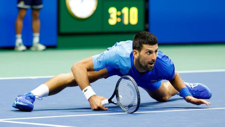 Novak Djokovic watches his shot while falling on the court as he plays Russia’s Daniil Medvedev in the US Open tennis tournament men’s singles final match at the USTA Billie Jean King National Tennis Center in New York on September 10, 2023. AFPPIX
