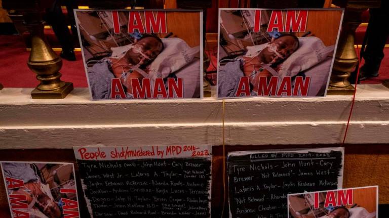Posters showing Tyre Nichols in his hospital bed and the names of those who have been shot by Memphis police department are displayed during a news conference at Mason Temple: Church of God in Christ World Headquarters in Memphis, Tennessee, on January 31, 2023/AFPPix