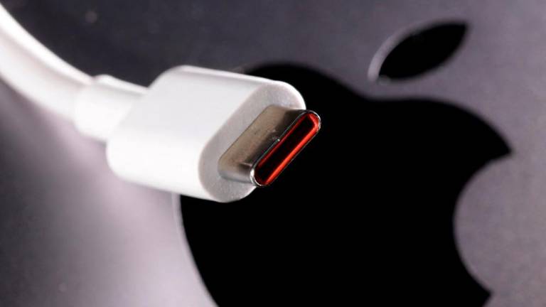A USB-C (USB Type-C) cable is seen near the Apple logo in this illustration taken October 27, 2022/REUTERSPix
