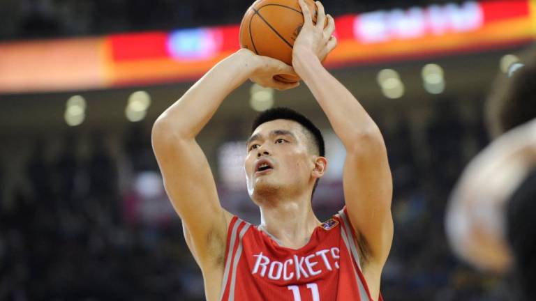 (FILES) In this file photo taken on October 13, 2010, Houston Rockets All-Star Yao Ming takes a penalty shot during their match against the New Jersey Nets in the NBA China Games 2010 basketball match at the Wukesong Arena in Beijing. AFPPIX