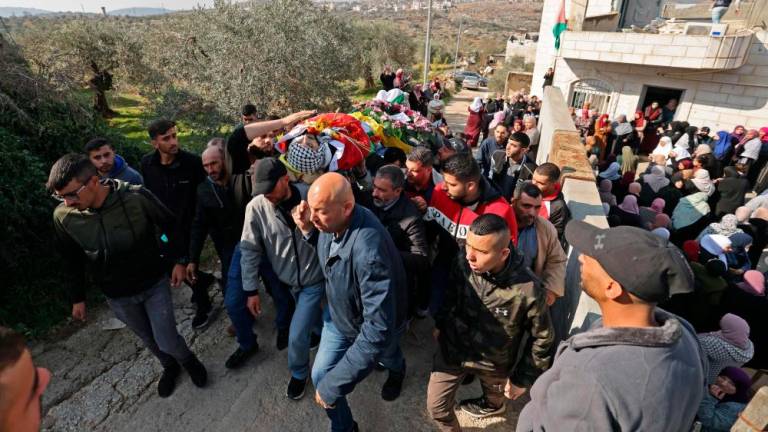 Palestinian mourners attend the funeral procession of Muhajid Mahmoud Hamed, in the village of Silwad, in the Israeli-occupied West Bank, on December 8, 2022. AFPPIX
