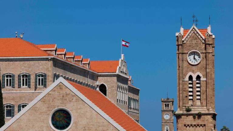 A Church’s clock tower (front) next to the governmental palace in Beirut indicates the new summer time on March 27, 2023. AFPPIX