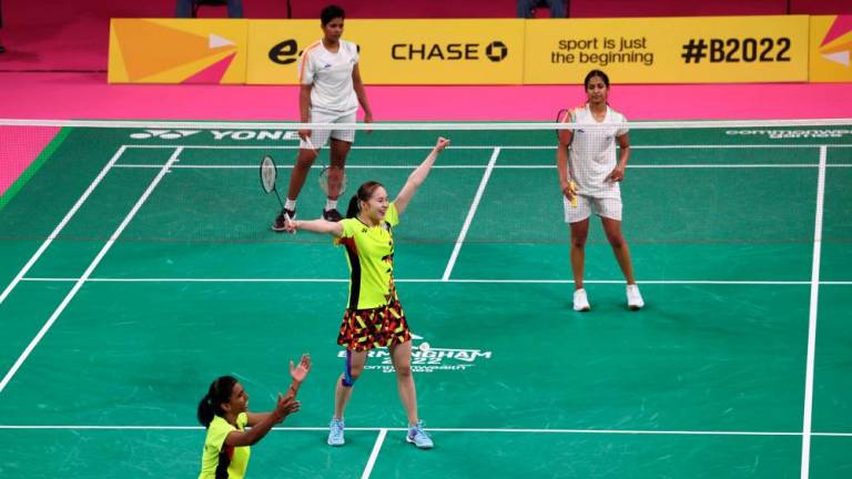Malaysia's Koong Le Pearly Tan and Muralitharan Thinaah (L) celebrate victory over India's Gayatri Gopichand Pullela and Treesa Jolly to clinch gold in the Mixed Team Gold Medal badminton match between Malaysia and India on day five of the Commonwealth Games at the NEC Arena in Birmingham, central England, on August 2, 2022. AFPPIX