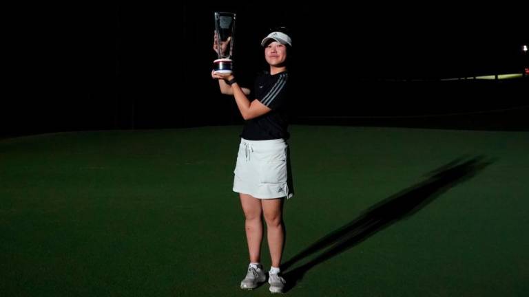 Natasha Oon with the trophy after her first professional win. (Photo by Epson Tour)