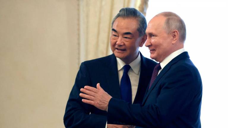 In this pool photograph distributed by Russian state owned Sputnik agency on September 20, 2023, Russia’s President Vladimir Putin (R) shakes hands with Chinese Foreign Minister Wang Yi, in Saint Petersburg. AFPPIX