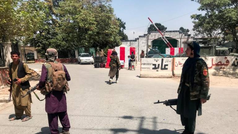 Taliban forces stand guard inside Kabul, Afghanistan August 16, 2021. - REUTERSPIX