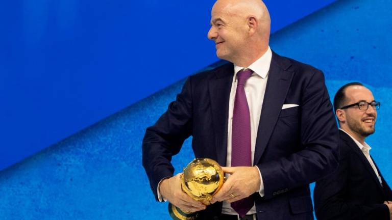 Gianni Infantino, President of FIFA carries the FIFA World Cup trophy after a panel discussion at the World Economic Forum 2022 (WEF) in the Alpine resort of Davos, Switzerland May 23, 2022. REUTERSPIX
