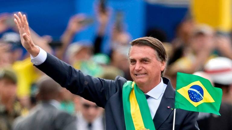 (FILES) In this file photo taken on September 07, 2022. Brazilian President Jair Bolsonaro waves at the crowd during a military parade to mark Brazil’s 200th anniversary of independence in Brasilia. AFPPIX