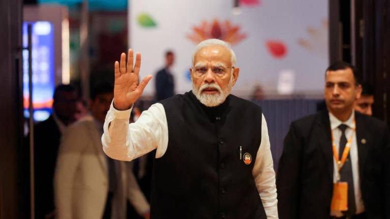 Indian Prime Minister Narendra Modi waves as he visits International Media Center, on the second day of the G20 summit in New Delhi, India, September 10, 2023. REUTERSPIX