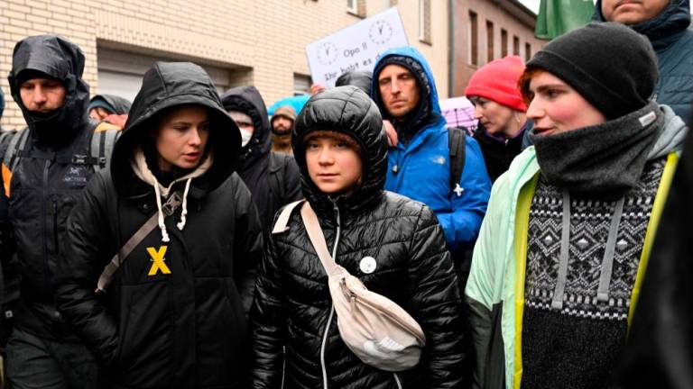 Swedish Climate activist Greta Thunberg (C)and German Climate activist Luisa Neubauer (2L) take part in a large-scale protest to stop the demolition of the village Luetzerath to make way for an open-air coal mine extension on January 14, 2023. AFPPIX
