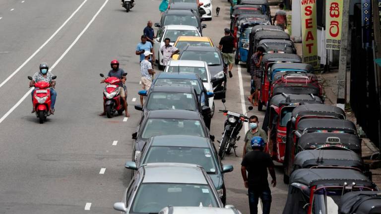 Drivers in their vehicles wait in a queue to buy petrol at a fuel station, amid the country's economic crisis in Colombo, Sri Lanka, May 16, 2022. REUTERSpix