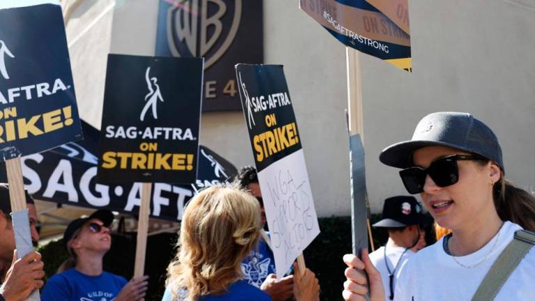 BURBANK, CALIFORNIA - SEPTEMBER 26: Striking SAG-AFTRA members picket outside Warner Bros. Studio as the actors strike continues on September 26, 2023 in Burbank, California. AFPPIX