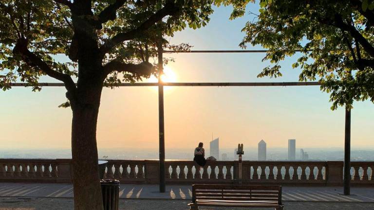 A woman sitting at the Fourviere esplanade looks at the city of Lyon after sunrise as France issued a “red alert” for four southern regions amid a spell of excessively hot weather, especially in the Rhone valley, France, August 22, 2023. REUTERSPIX