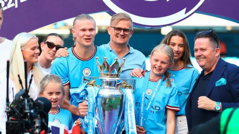 Erling Haaland celebrates with his dad Alf-Inge and family with the trophy after winning the Premier League/REUTERSPIX