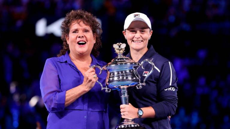 FILE PHOTO: Tennis - Australian Open - Women’s Singles Final - Melbourne Park, Melbourne, Australia - January 29, 2022 Australia’s Ashleigh Barty celebrates as she holds the trophy while she poses with former Australian Open champion Evonne Goolagong Cawley after she won the final against Danielle Collins of the U.S. REUTERSpix