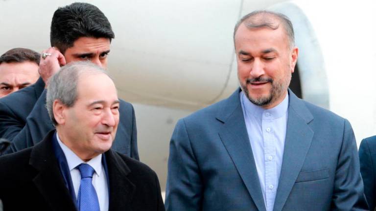 Syrian Foriegn Minister Faisal Mekdad (L) welcomes his Iranian counterpart Hossein Amir-Abdollahian (R) at Damascus airport on January 14, 2023. Amir-Abdollahian arrived in the Syrian capital after a visit to neighbouring Lebanon at a time of warming ties between Syria and Turkey. AFPPIX