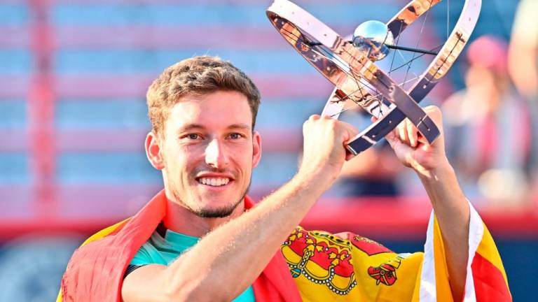 MONTREAL, QUEBEC - AUGUST 14: Pablo Carreno Busta of Spain holds up the National Bank Open trophy after defeating Hubert Hurkacz of Poland in the final round during Day 9 of the National Bank Open at Stade IGA on August 14, 2022 in Montreal, Canada. Pablo Carreno Busta defeated Hubert Hurkacz 3-6, 6-3, 6-3. AFPPIX