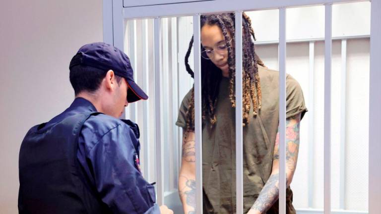 US basketball player Brittney Griner stands in a defendants' cage before a court hearing during her trial on charges of drug smuggling, in Khimki, outside Moscow on August 2, 2022. AFPPIX