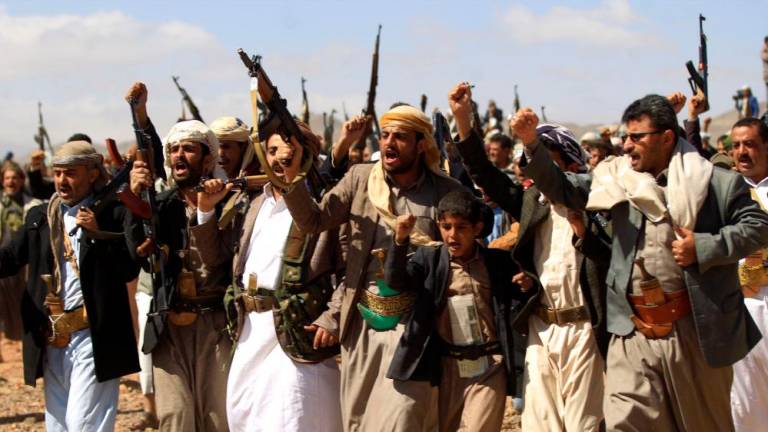 In this file photo taken on February 21, 2019, armed men raise their weapons as they gather near the capital Sanaa to show their support to the Shiite Huthi movement against the Saudi-led intervention. AFPPIX