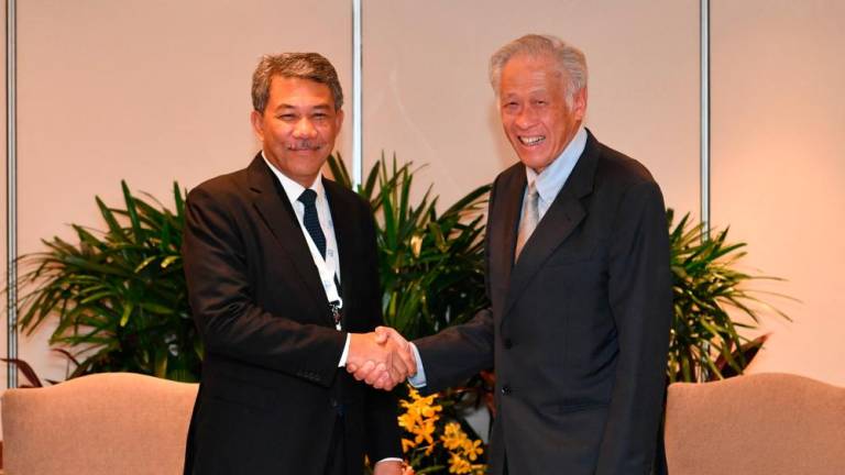 Dato’ Seri Mohamad Hasan meets with Singapore’s Minister for Defence Ng Eng Hen on the sidelines of the 20th Shangri-La Dialogue in Singapore June 2, 2023. REUTERSPIX