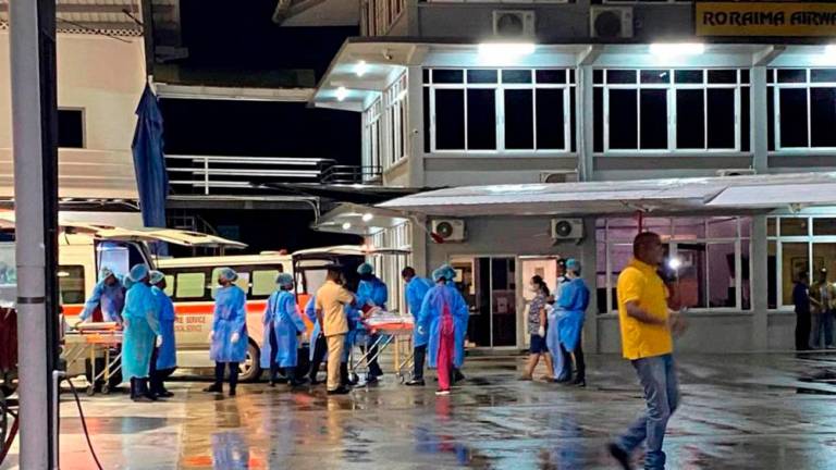 Children rescued during a Mahdia secondary school dormitory fire are transferred by medical personnel to hospitals in Gorgetown, Guyana on May 22, 2023/AFPPix