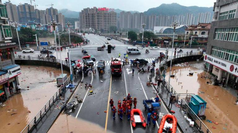 An aerial view shows rescue workers and floodwaters near Shuinan Bridge following heavy rainfall in Jianou, Fujian province, China June 19, 2022. REUTERSPIX