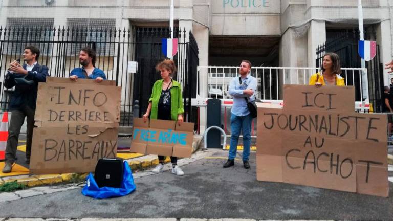 Protesters hold placards reading “information behind bars” (L) and “here, journalist in jail” as they demonstrate in front of the police headquarters in Marseille, southern France, in support of journalist Ariane Lavrilleux, who has been taken into police custody as part of an investigation into the compromise of national defense secrets, on September 20, 2023. AFPPIX